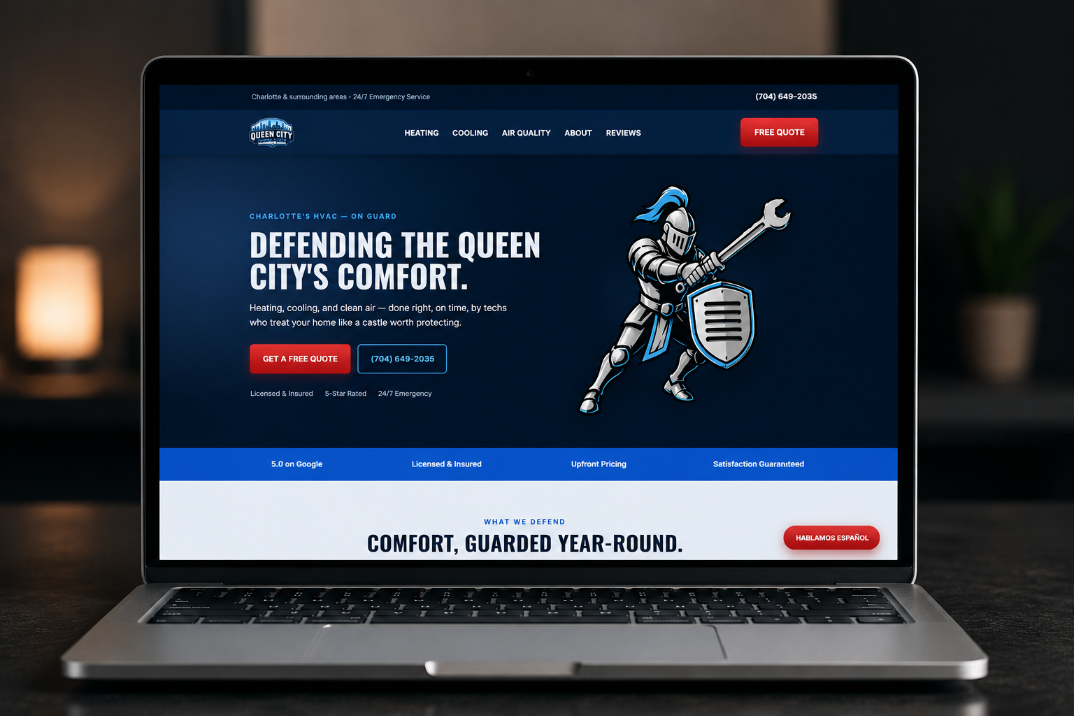 Queen City Comfort Guard bilingual website shown on a laptop
